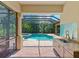 Screened pool and spa with adjacent outdoor kitchen at 12313 Baypointe Ter, Cortez, FL 34215