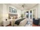 Bright bedroom featuring a ceiling fan, an area rug, and sliding glass doors to the outdoor living area at 2570 Tom Morris Dr, Sarasota, FL 34240