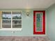 Modern red front door and light-green exterior at 5680 Blount Ave, Sarasota, FL 34231