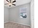 Well-lit bedroom featuring carpet and ceiling fan at 14573 Ponce De Leon Trl, Port Charlotte, FL 33981