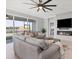 Open living area with gray sofas, fireplace, and lake view at 14573 Ponce De Leon Trl, Port Charlotte, FL 33981