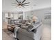 Open concept living room with gray sofas and kitchen views at 14573 Ponce De Leon Trl, Port Charlotte, FL 33981