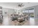 Bright and airy living room with gray sofas and a view of the lake at 14573 Ponce De Leon Trl, Port Charlotte, FL 33981