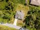 Single-story house on a lot surrounded by trees at 1702 Rada Ln, North Port, FL 34288