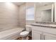 Bathroom with tub, granite countertop, and white cabinets at 1702 Rada Ln, North Port, FL 34288