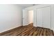 Bedroom with double door closet and wood-look flooring at 1702 Rada Ln, North Port, FL 34288