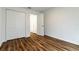 Bedroom with double door closet and wood-look flooring at 1702 Rada Ln, North Port, FL 34288