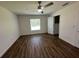 Bright bedroom with hardwood floors and ceiling fan at 1702 Rada Ln, North Port, FL 34288