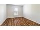 Bright bedroom with wood-look flooring and window coverings at 1702 Rada Ln, North Port, FL 34288