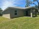 Backyard view showing a covered patio and lush green grass at 1702 Rada Ln, North Port, FL 34288