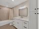 Simple bathroom with white vanity and taupe tile at 2806 67Th W St, Bradenton, FL 34209