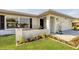 Inviting front porch features wicker chairs and a well-manicured garden bed adding to the curb appeal of the home at 2806 67Th W St, Bradenton, FL 34209