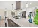 Kitchen island with quartz countertop, breakfast bar seating, and modern lighting at 2806 67Th W St, Bradenton, FL 34209