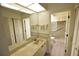 Double sink bathroom with access to a shower and linen closet at 3154 Windrush Bourne # 23, Sarasota, FL 34235