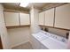 Bright laundry room, washer, dryer, and ample storage at 3154 Windrush Bourne # 23, Sarasota, FL 34235