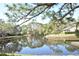 Peaceful pond view with lush landscaping and homes at 3154 Windrush Bourne # 23, Sarasota, FL 34235