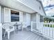 Cozy front porch with white chairs and a small table at 3333 26Th E Ave # 1230, Bradenton, FL 34208