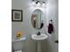 Small bathroom with pedestal sink, oval mirror and updated fixtures at 12271 Lavender Loop, Bradenton, FL 34212