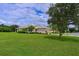 One-story house with well-manicured lawn and large tree at 12271 Lavender Loop, Bradenton, FL 34212