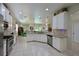 Modern kitchen with white cabinets, granite countertops, and stainless steel appliances at 12271 Lavender Loop, Bradenton, FL 34212