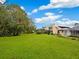 Landscaped backyard with mature trees at 5050 Kestral Park S Way, Sarasota, FL 34231