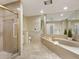 Elegant bathroom with a large bathtub and shower at 5050 Kestral Park S Way, Sarasota, FL 34231