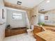 Bathroom with brown marble bathtub and vanity with granite countertop at 5050 Kestral Park S Way, Sarasota, FL 34231