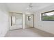 Bright bedroom with mirrored closet doors and neutral carpeting at 5050 Kestral Park S Way, Sarasota, FL 34231