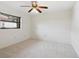 Simple bedroom with ceiling fan and neutral carpeting at 5050 Kestral Park S Way, Sarasota, FL 34231