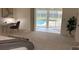 Bedroom with pool view and sitting area at 5050 Kestral Park S Way, Sarasota, FL 34231