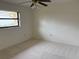 Simple bedroom with window and ceiling fan at 5050 Kestral Park S Way, Sarasota, FL 34231