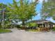 Community clubhouse with covered entryway and landscaping at 5050 Kestral Park S Way, Sarasota, FL 34231