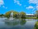 Scenic pond with fountain and lush landscaping at 5050 Kestral Park S Way, Sarasota, FL 34231