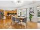 Bright dining room with hardwood floors and kitchen views at 5050 Kestral Park S Way, Sarasota, FL 34231