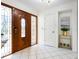 Bright entryway with wood door and tile floors at 5050 Kestral Park S Way, Sarasota, FL 34231