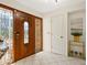 Bright entryway with hardwood floors, a wooden door, and stained glass at 5050 Kestral Park S Way, Sarasota, FL 34231