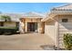 Front entrance with stone accents and a two-car garage at 5050 Kestral Park S Way, Sarasota, FL 34231