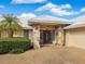 Inviting entrance with stone pillars, a double door, and lush landscaping at 5050 Kestral Park S Way, Sarasota, FL 34231