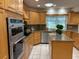 Spacious kitchen featuring granite countertops and stainless steel appliances at 5050 Kestral Park S Way, Sarasota, FL 34231