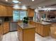 Kitchen with granite island, ample cabinetry, and views to Gathering room at 5050 Kestral Park S Way, Sarasota, FL 34231