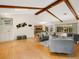 Living room with hardwood floors, exposed beams, and views of the pool at 5050 Kestral Park S Way, Sarasota, FL 34231