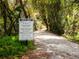 Peaceful nature trail through lush vegetation at 5050 Kestral Park S Way, Sarasota, FL 34231