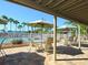 Covered patio with tables and chairs overlooking the pool at 5050 Kestral Park S Way, Sarasota, FL 34231