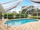 Inviting kidney-shaped pool with screened enclosure at 5050 Kestral Park S Way, Sarasota, FL 34231