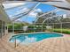 Inviting kidney-shaped pool with screened enclosure at 5050 Kestral Park S Way, Sarasota, FL 34231