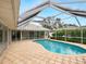 Large kidney shaped pool with screened patio and access to home at 5050 Kestral Park S Way, Sarasota, FL 34231