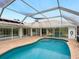 Spacious pool and patio area with screened enclosure at 5050 Kestral Park S Way, Sarasota, FL 34231