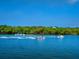 Jet skiers and motorboat enjoy a sunny day on the calm water at 5050 Kestral Park S Way, Sarasota, FL 34231