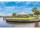 Scenic view of a waterfront gazebo surrounded by lush landscaping in Englewood, Florida at 929 Suncrest Ln, Englewood, FL 34223