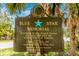 Blue Star Memorial sign surrounded by tropical trees at 929 Suncrest Ln, Englewood, FL 34223
